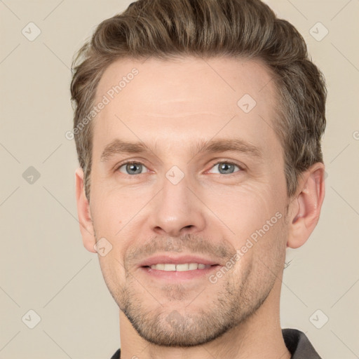 Joyful white adult male with short  brown hair and grey eyes