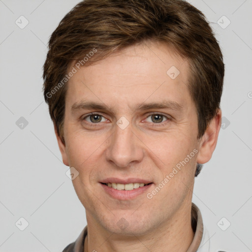 Joyful white adult male with short  brown hair and grey eyes