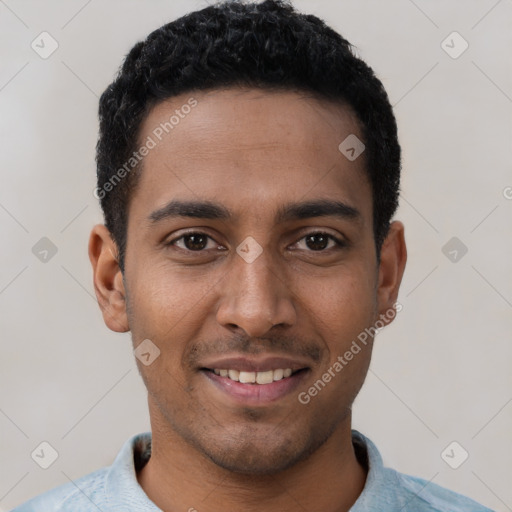 Joyful black young-adult male with short  black hair and brown eyes