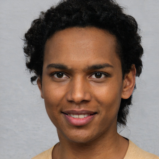 Joyful black young-adult male with short  black hair and brown eyes