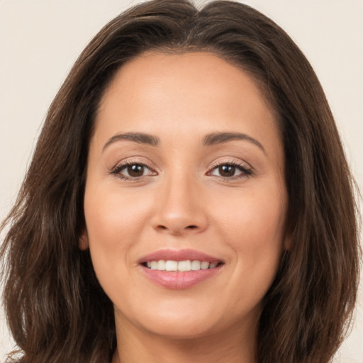 Joyful white young-adult female with long  brown hair and brown eyes