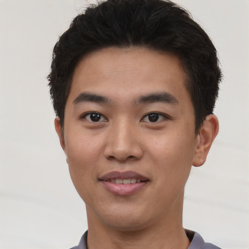 Joyful asian young-adult male with short  brown hair and brown eyes