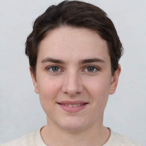 Joyful white young-adult female with short  brown hair and grey eyes