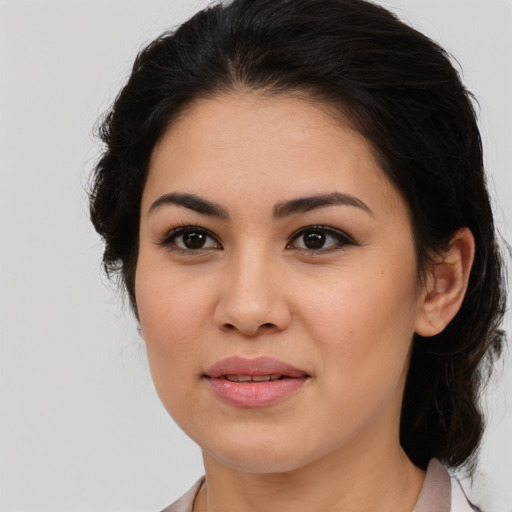 Joyful latino young-adult female with medium  brown hair and brown eyes