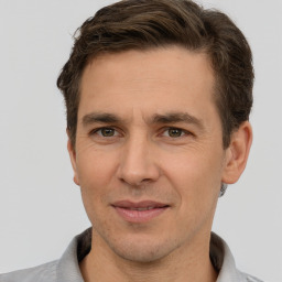 Joyful white adult male with short  brown hair and brown eyes