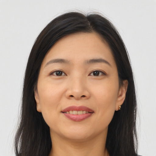 Joyful asian young-adult female with long  brown hair and brown eyes