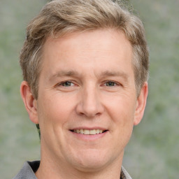 Joyful white adult male with short  brown hair and grey eyes