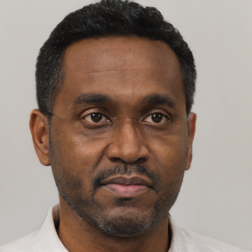 Neutral black adult male with short  black hair and brown eyes