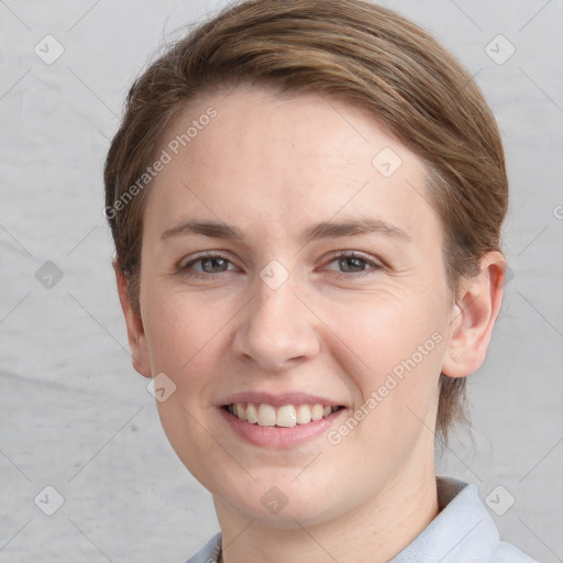 Joyful white young-adult female with short  brown hair and grey eyes