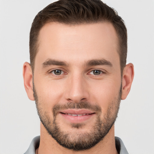 Joyful white young-adult male with short  brown hair and brown eyes