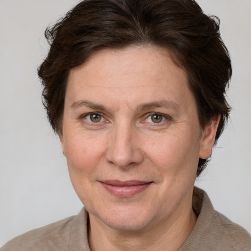 Joyful white adult female with short  brown hair and grey eyes