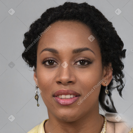 Joyful black young-adult female with long  black hair and brown eyes