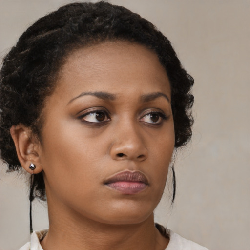 Neutral black young-adult female with medium  brown hair and brown eyes