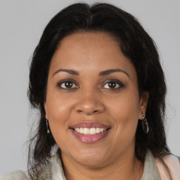 Joyful black adult female with medium  brown hair and brown eyes