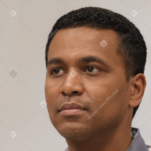 Neutral latino young-adult male with short  black hair and brown eyes