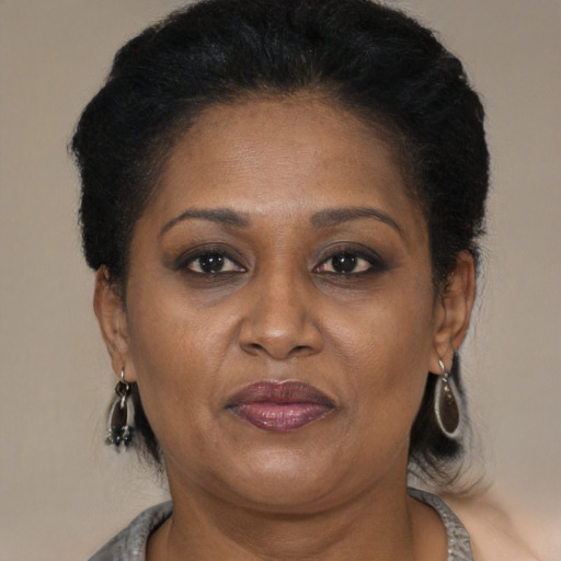 Joyful black adult female with short  brown hair and brown eyes