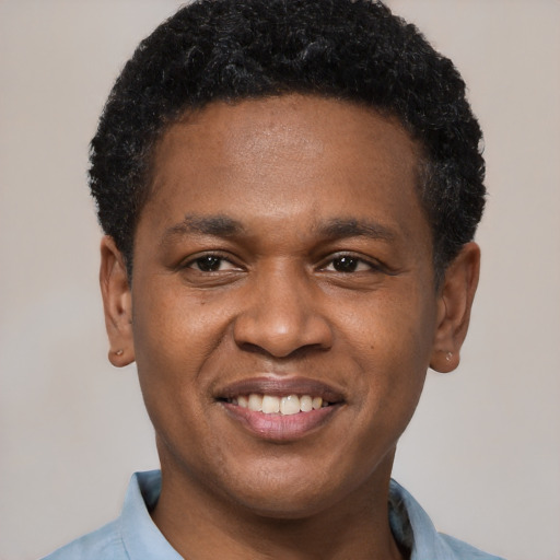 Joyful black young-adult male with short  black hair and brown eyes