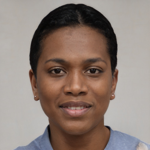 Joyful black young-adult female with short  black hair and brown eyes