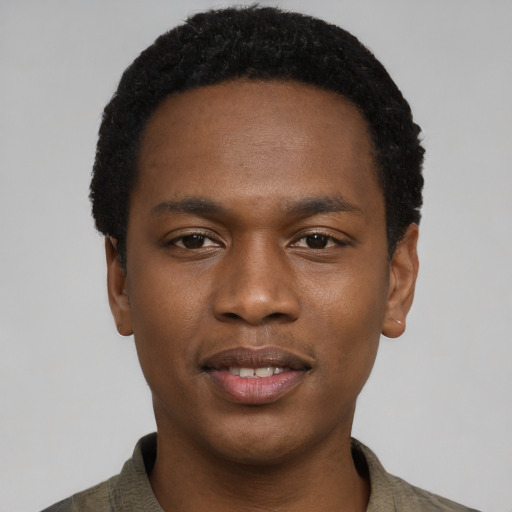Joyful black young-adult male with short  black hair and brown eyes
