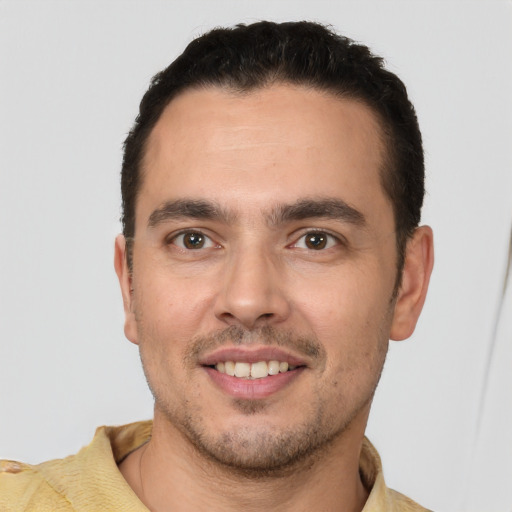 Joyful white young-adult male with short  brown hair and brown eyes