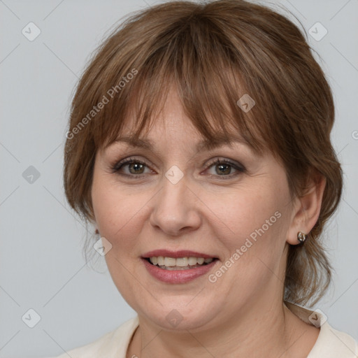 Joyful white adult female with medium  brown hair and grey eyes