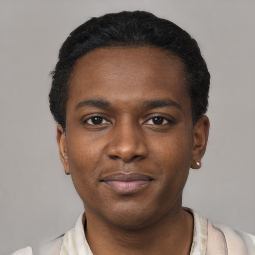 Joyful black young-adult male with short  black hair and brown eyes