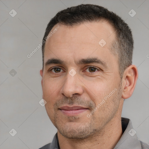 Joyful white adult male with short  black hair and brown eyes