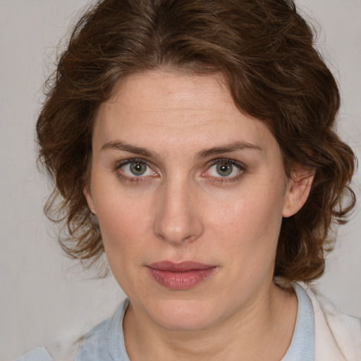 Joyful white young-adult female with medium  brown hair and green eyes