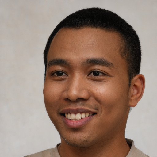 Joyful latino young-adult male with short  black hair and brown eyes
