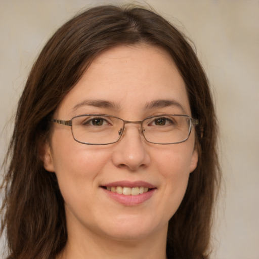 Joyful white young-adult female with medium  brown hair and green eyes