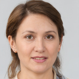 Joyful white adult female with medium  brown hair and brown eyes