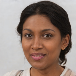 Joyful black young-adult female with medium  brown hair and brown eyes