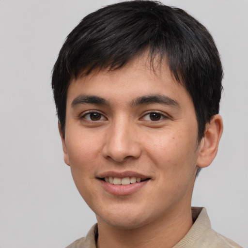 Joyful white young-adult male with short  black hair and brown eyes