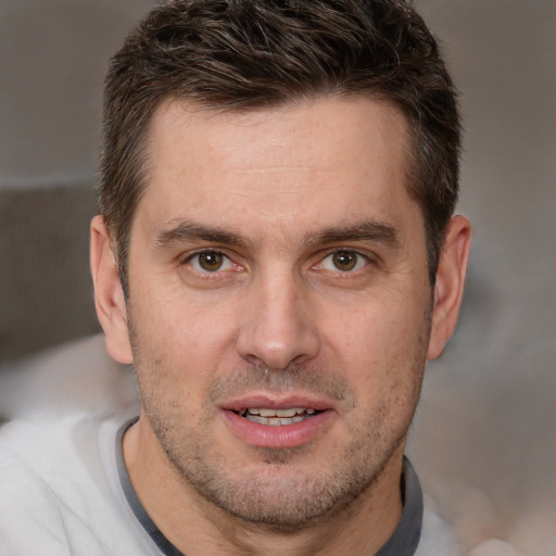 Joyful white adult male with short  brown hair and brown eyes