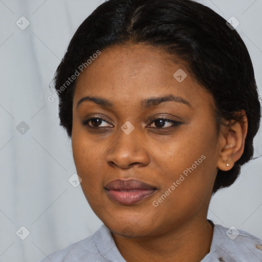 Joyful black young-adult female with short  black hair and brown eyes