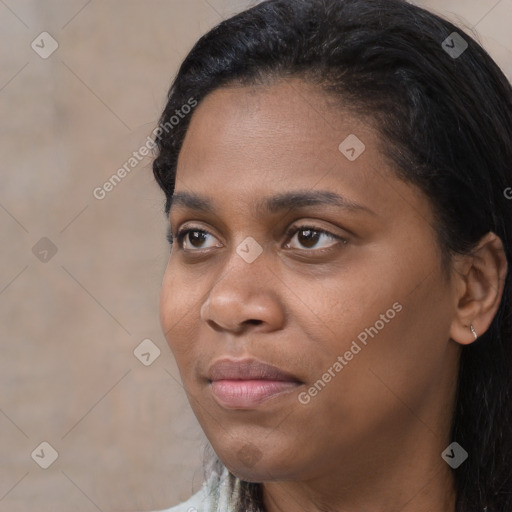 Joyful black young-adult female with long  black hair and brown eyes