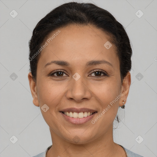 Joyful latino young-adult female with short  brown hair and brown eyes