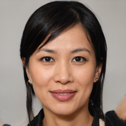 Joyful white young-adult female with medium  black hair and brown eyes