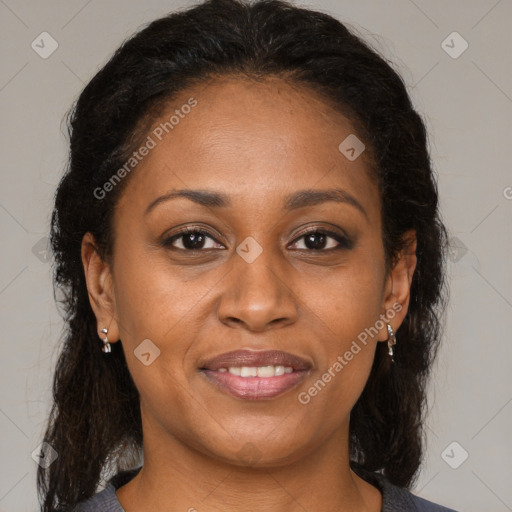 Joyful black adult female with medium  brown hair and brown eyes