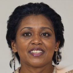 Joyful black adult female with medium  brown hair and brown eyes