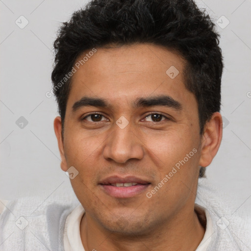 Joyful latino young-adult male with short  black hair and brown eyes