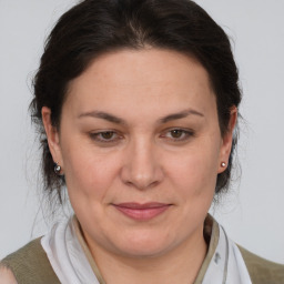 Joyful white adult female with medium  brown hair and brown eyes