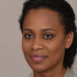 Joyful black young-adult female with medium  brown hair and brown eyes