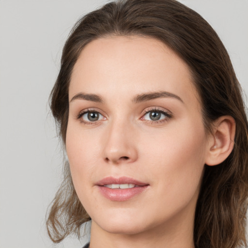 Joyful white young-adult female with medium  brown hair and green eyes