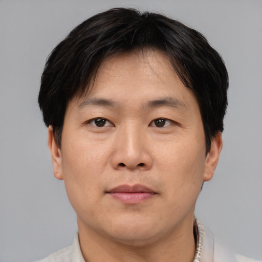 Neutral asian adult male with short  brown hair and brown eyes