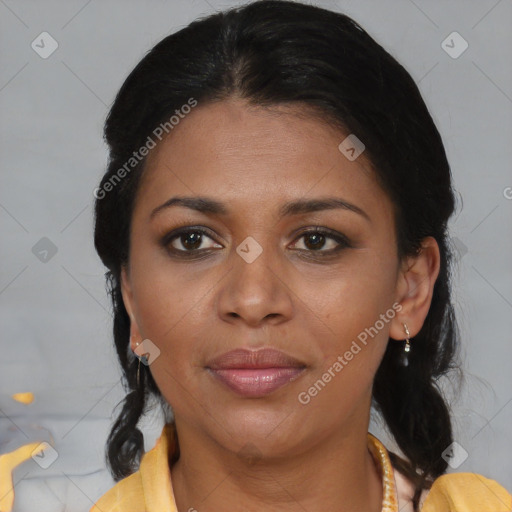 Joyful latino adult female with medium  brown hair and brown eyes