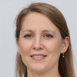 Joyful white adult female with long  brown hair and grey eyes