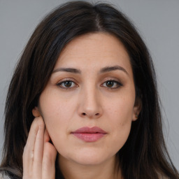 Joyful white young-adult female with long  brown hair and brown eyes