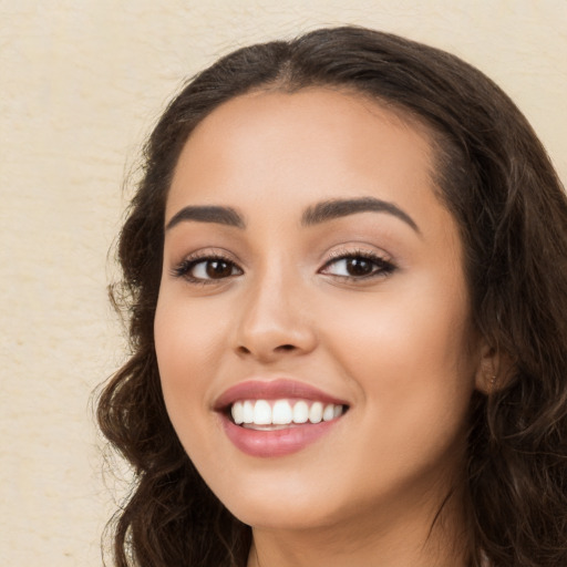 Joyful white young-adult female with long  brown hair and brown eyes