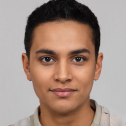 Joyful latino young-adult male with short  brown hair and brown eyes